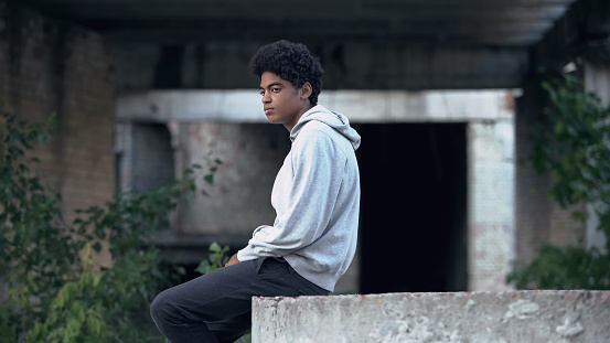 Depressed lonely black male sitting abandoned building thinking of problem