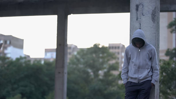 Upset afro-american teenager thinking about life problems, experiencing break up