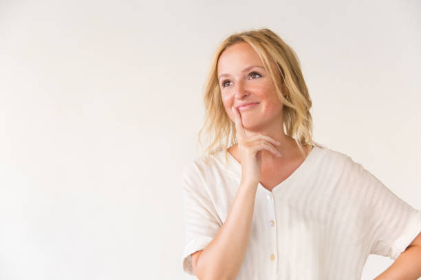 istock Cheerful young woman looking at copy space away 1183330487