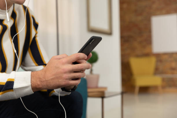 istock Young man at home using a smartphone 1183332898