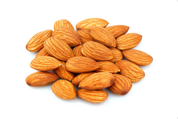 istock Closeup of almonds isolated. 1183333221