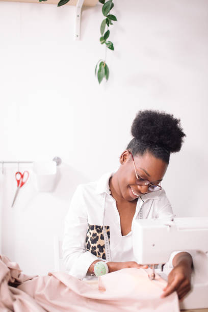 istock african seamstress sews clothes 1183334573