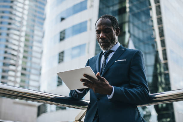 istock Elegant Businessman Working on a Tablet 1183334594