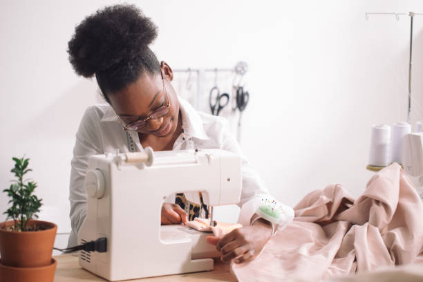 istock african seamstress sews clothes 1183334711