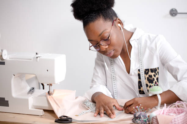 istock african seamstress working with fabric takes measures 1183334924