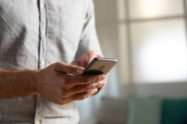 istock Young man at home using a smartphone 1183335640