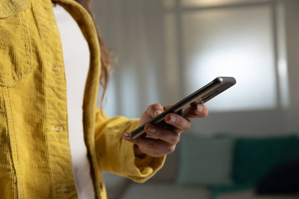 istock Young woman at home using a smartphone 1183335648