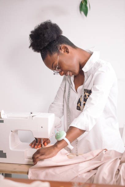 istock african seamstress sews clothes 1183335727