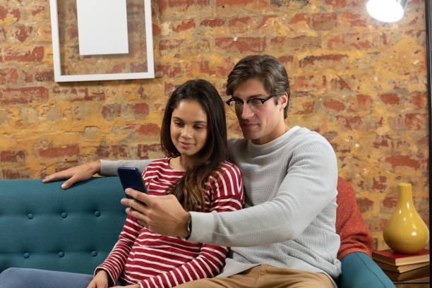istock Young couple relaxing at home using a smartphone together 1183335795