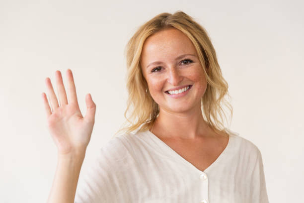 istock Cheerful woman waving hand 1183335833