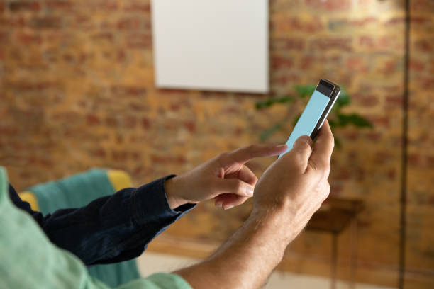 istock Young couple at home using a smartphone 1183336939