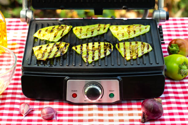 Green fried bell pepper lies on grill stock photo
