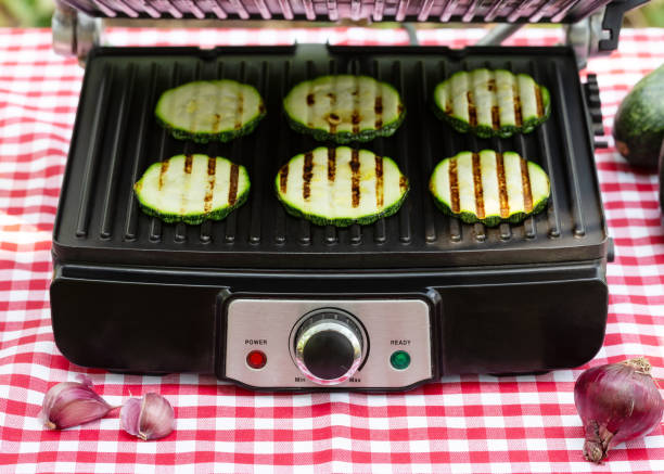 istock Sliced fried striped zucchini on electric grill 1183338458