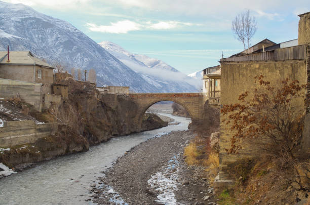 Stone arch bridge and river in the ancient mountain village. Nature and travel. Russia, North Caucasus, Dagestan, Akhty administrative center of Akhtynsky District north caucasus photos stock pictures, royalty-free photos & images