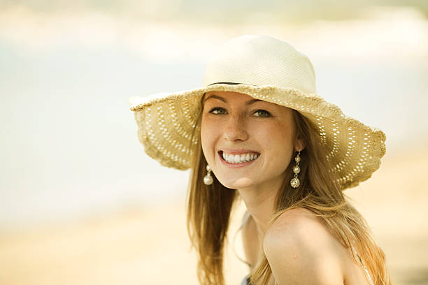 istock Beautiful young woman smiling on the beach 118334190
