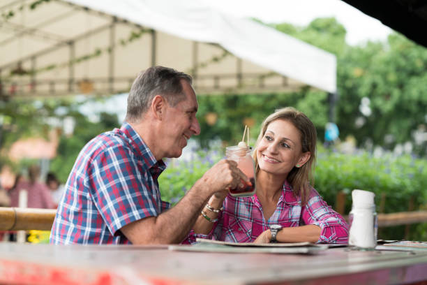 istock Older couple is toasting with drinks in a restaurant 1183342906