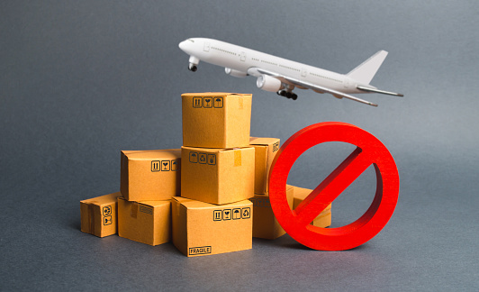 Cargo plane, many boxes and red prohibition symbol NO. Embargo trade wars. Restriction on importation, ban transit export dual-use goods to countries under sanctions. transport companies.