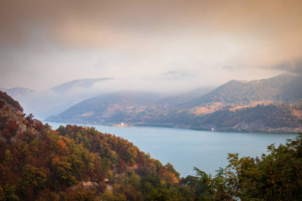 istock Autumn morning on the river surrounded by mountains 1183344209
