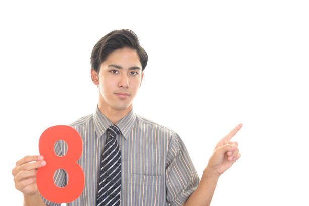 istock Asian businessman holding unmber eight 1183345037