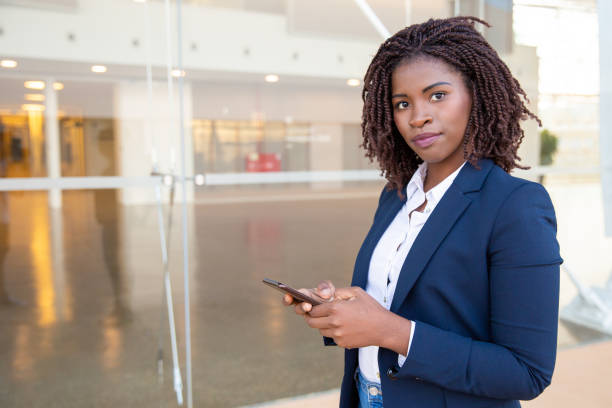istock Positive female employee texting message on cell 1183345258