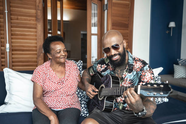 istock Son playing guitar to his mother 1183346500