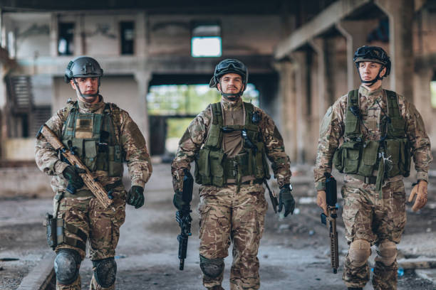 istock Soldiers walking in abandoned warehouse 1183347972