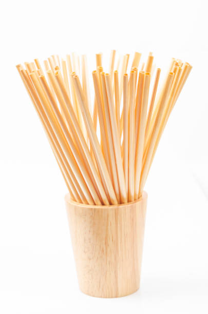 istock Wheat straw for drinking water in wooden glass 1183349228