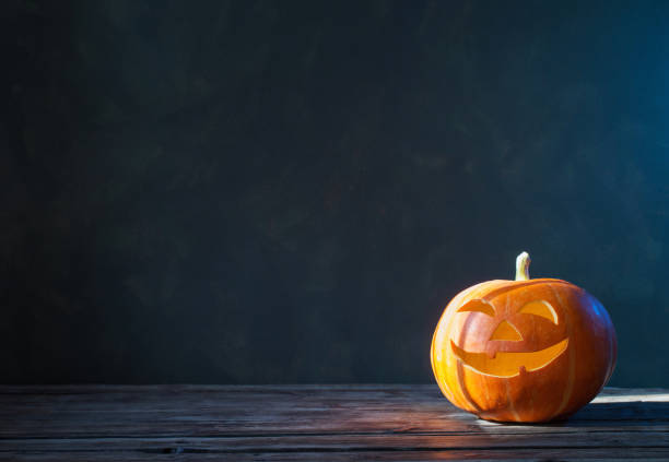 istock Halloween pumpkin on dark background 1183349452