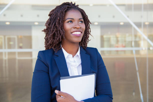 istock Happy excited professional with documents walking outside 1183349861