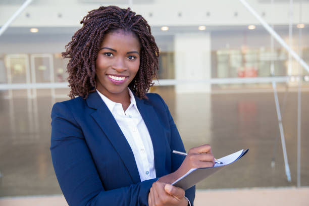 istock Happy cheerful manager completing survey outside 1183350443