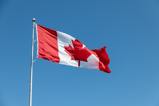Large Canadian flag flies in the wind
