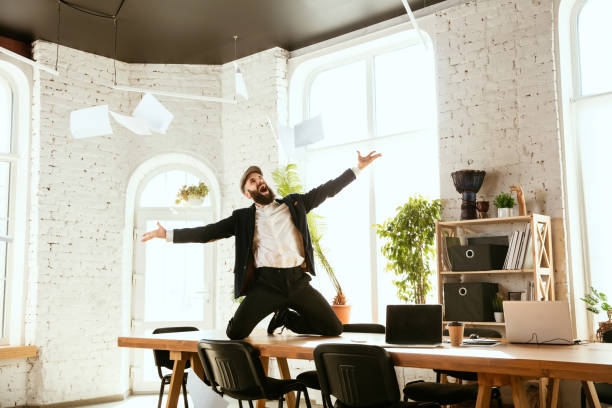 istock Businessman having fun dancing break dance in the office at work 1183352545