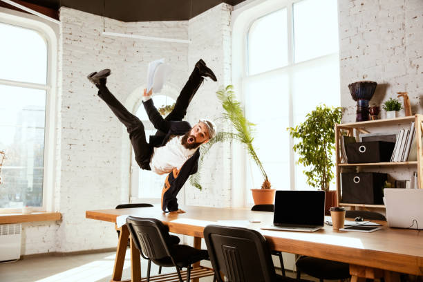 istock Businessman having fun dancing break dance in the office at work 1183352546
