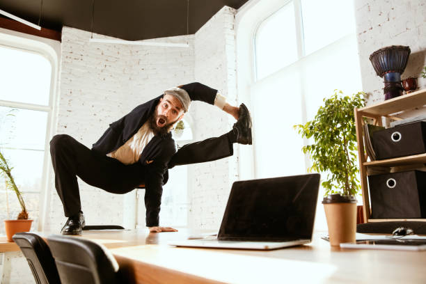 istock Businessman having fun dancing break dance in the office at work 1183352560