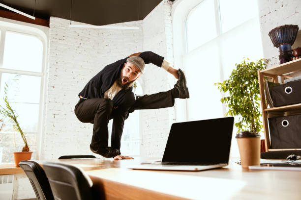 istock Businessman having fun dancing break dance in the office at work 1183352561