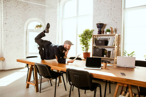 istock Businessman having fun dancing break dance in the office at work 1183352563