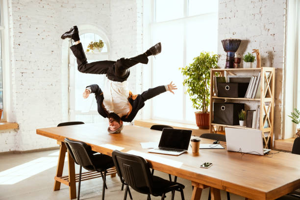 istock Businessman having fun dancing break dance in the office at work 1183352568