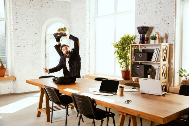 istock Businessman having fun dancing break dance in the office at work 1183352576