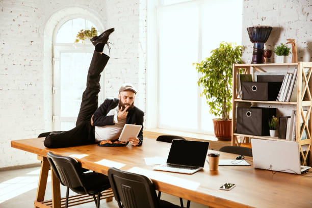 istock Businessman having fun dancing break dance in the office at work 1183352578