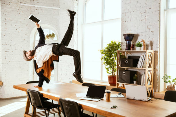 istock Businessman having fun dancing break dance in the office at work 1183352582