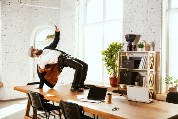 istock Businessman having fun dancing break dance in the office at work 1183352586