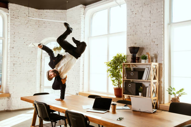 istock Businessman having fun dancing break dance in the office at work 1183352587