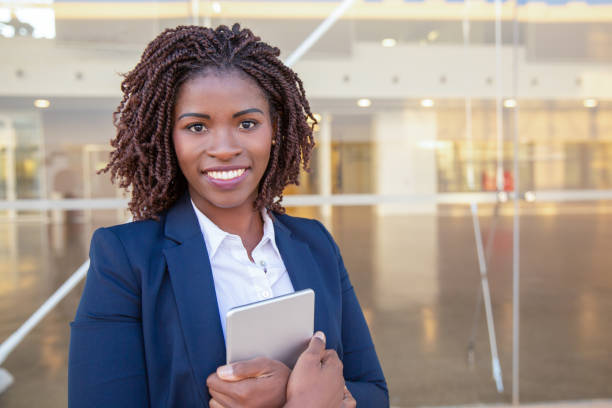 istock Happy employee with tablet posing near office building 1183353046