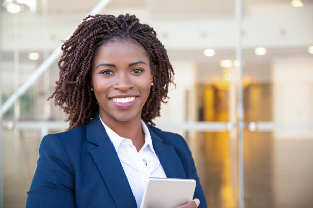 istock Happy joyful manager with tablet posing outside 1183354617