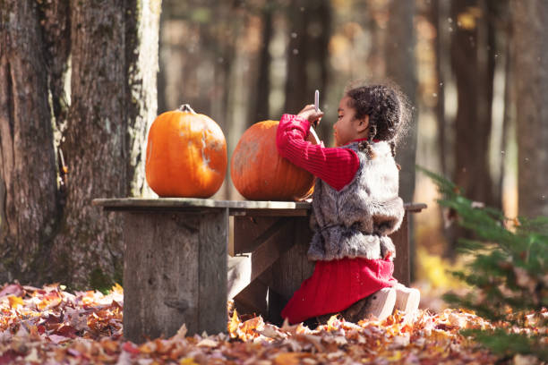 Mixed race family decoration pumpkins, during autumn, Quebec, Canada
