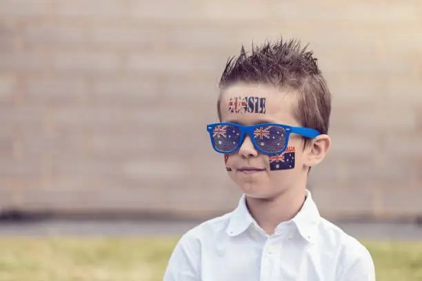 Photo of Australian boy with flag tattoo and sunglasses on Australia Day