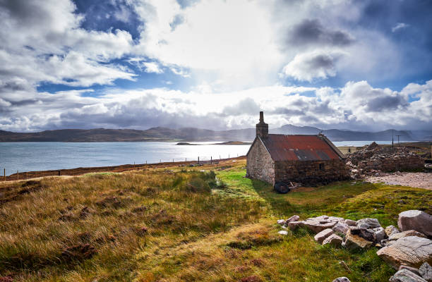 istock A small house stands in the grass by a lake. 1183362424