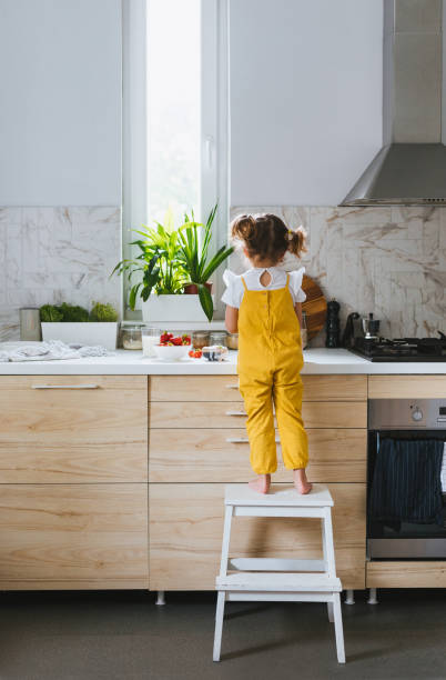 istock Little Girl Standing on Ladders 1183364309