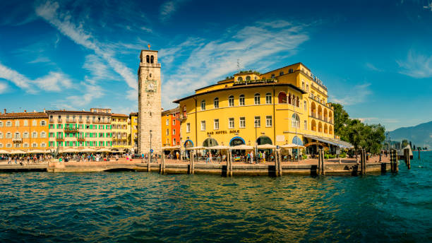 Riva del Garda, Italy - September, 5. 2019: Downtown Riva del Garda. Town square with restaurants and Clock tower .