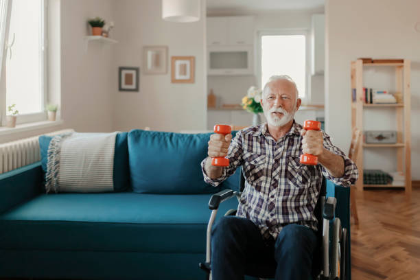 istock Senior Man in a Wheelchair using Dumbbells 1183364623